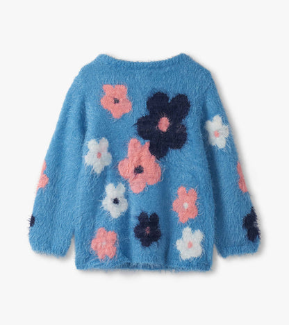 Furry blue sweater featuring colorful floral clusters in pink, white, and navy on the back.