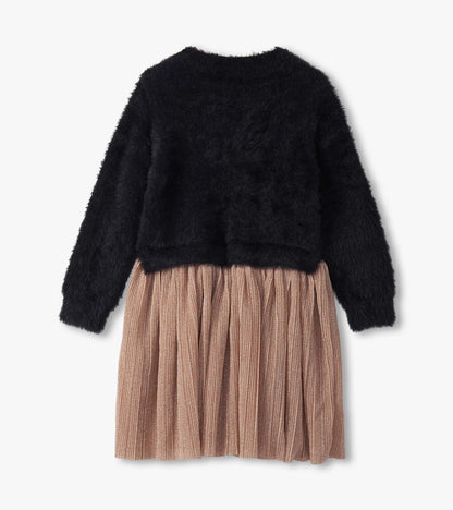 Black fuzzy top with long sleeves and a pleated, shimmery rose gold skirt. Back view of the dress.