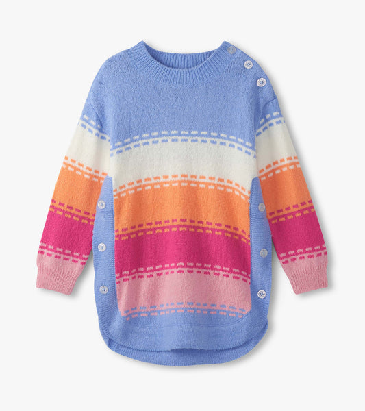 Chunky sweater tunic in blue, white, orange, pink with bold stripes and button details, featuring a rounded hem.