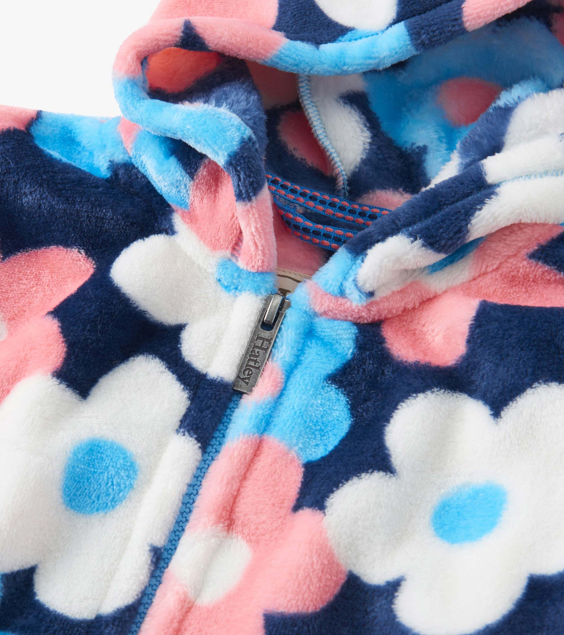 Fleece zip-up hoodie featuring a navy background with large pink, white, and blue floral patterns.