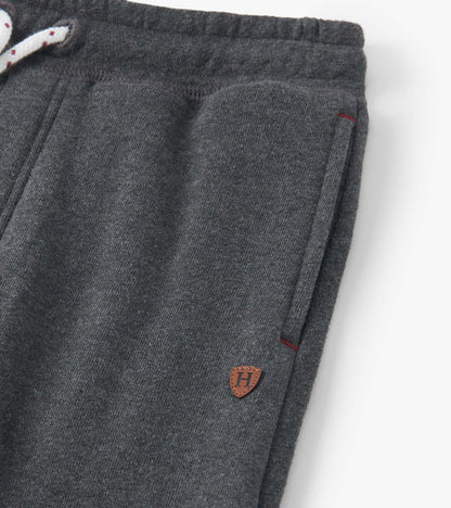 Charcoal melange joggers with a drawstring waist, side pockets, and a small logo patch. Soft fabric for comfort.