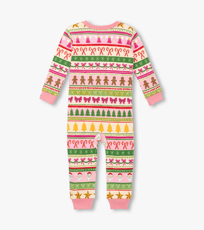 Pink cotton sleeper with festive Fair Isle pattern, featuring gingerbread, bows, and Christmas trees. Long sleeves and foote…