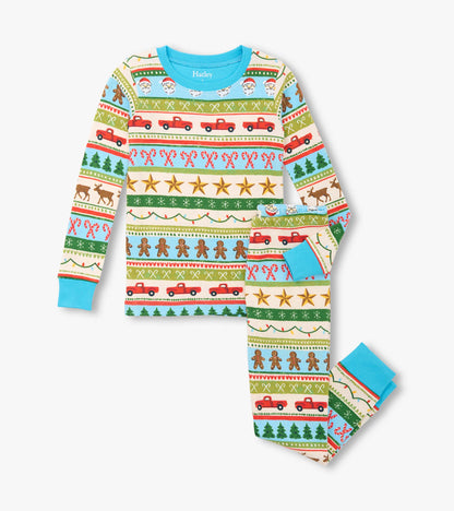 Blue cotton pyjama set featuring a festive Fair Isle pattern with Santa, trees, and gingerbread motifs.