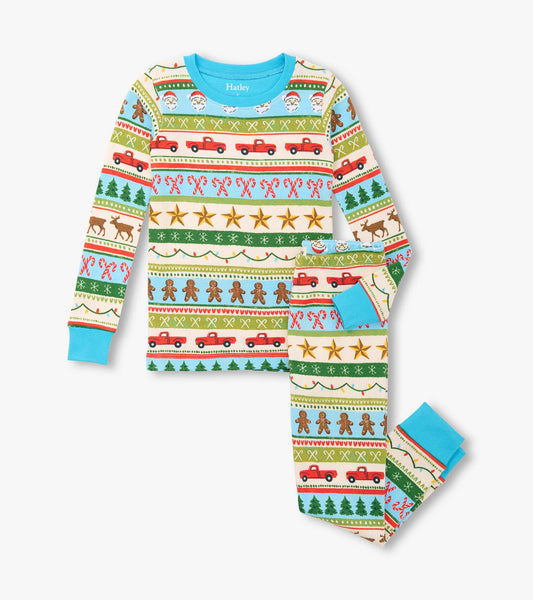 Blue cotton pyjama set featuring a festive Fair Isle pattern with Santa, trees, and gingerbread motifs.