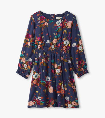 Navy dress with long sleeves, floral pattern in vibrant colors, smocked waist, suitable for special events.