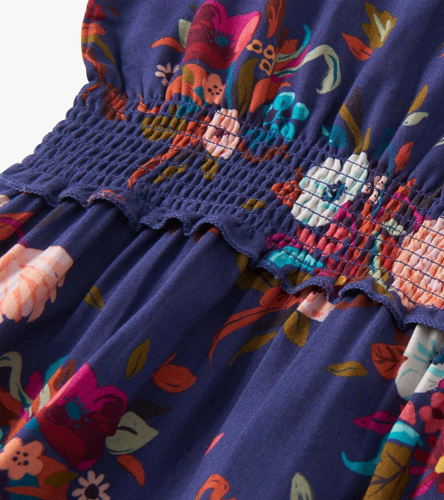 Navy dress with colorful floral pattern, smocked bodice, and flowing skirt, suitable for special events.