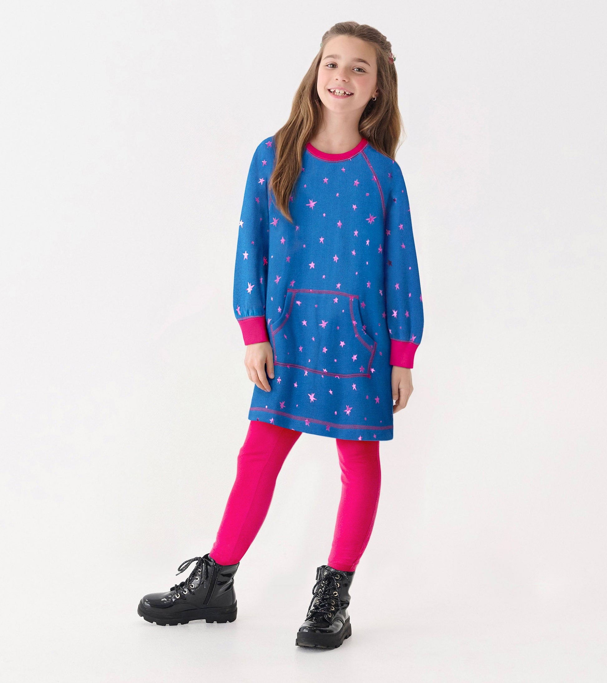 Blue sweater dress with pink foil stars, long sleeves, and a front pocket, paired with pink leggings and black boots.