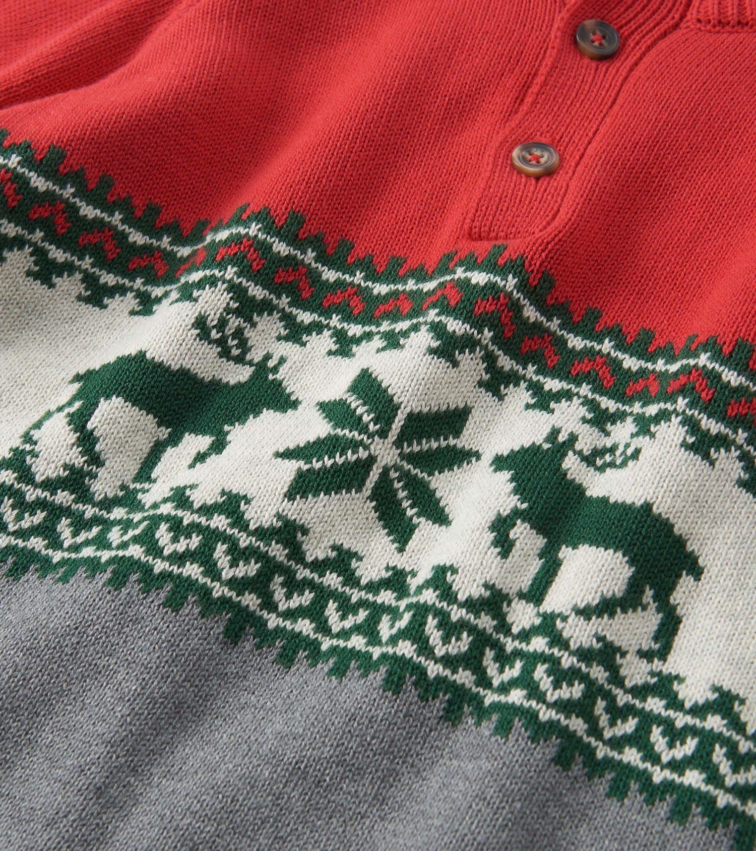 Red and gray mockneck sweater featuring a festive elk and snowflake pattern in green and white.