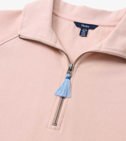 Pink mock neck pullover featuring a zip closure and a blue tassel detail, made from soft, textured fabric.