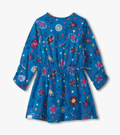 Blue cinched waist dress featuring a colorful music-themed pattern with records, hearts, and stars.