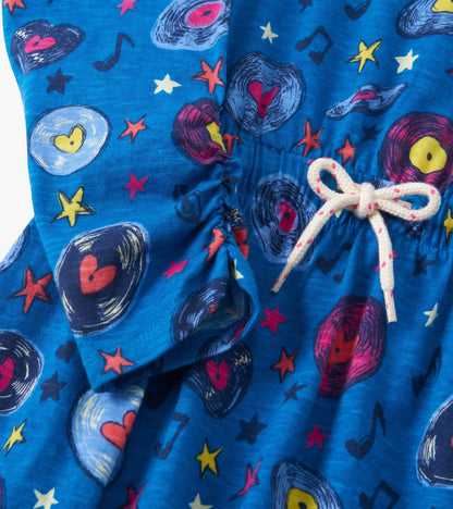Blue cinched waist dress featuring a vibrant music-themed pattern with records and stars.