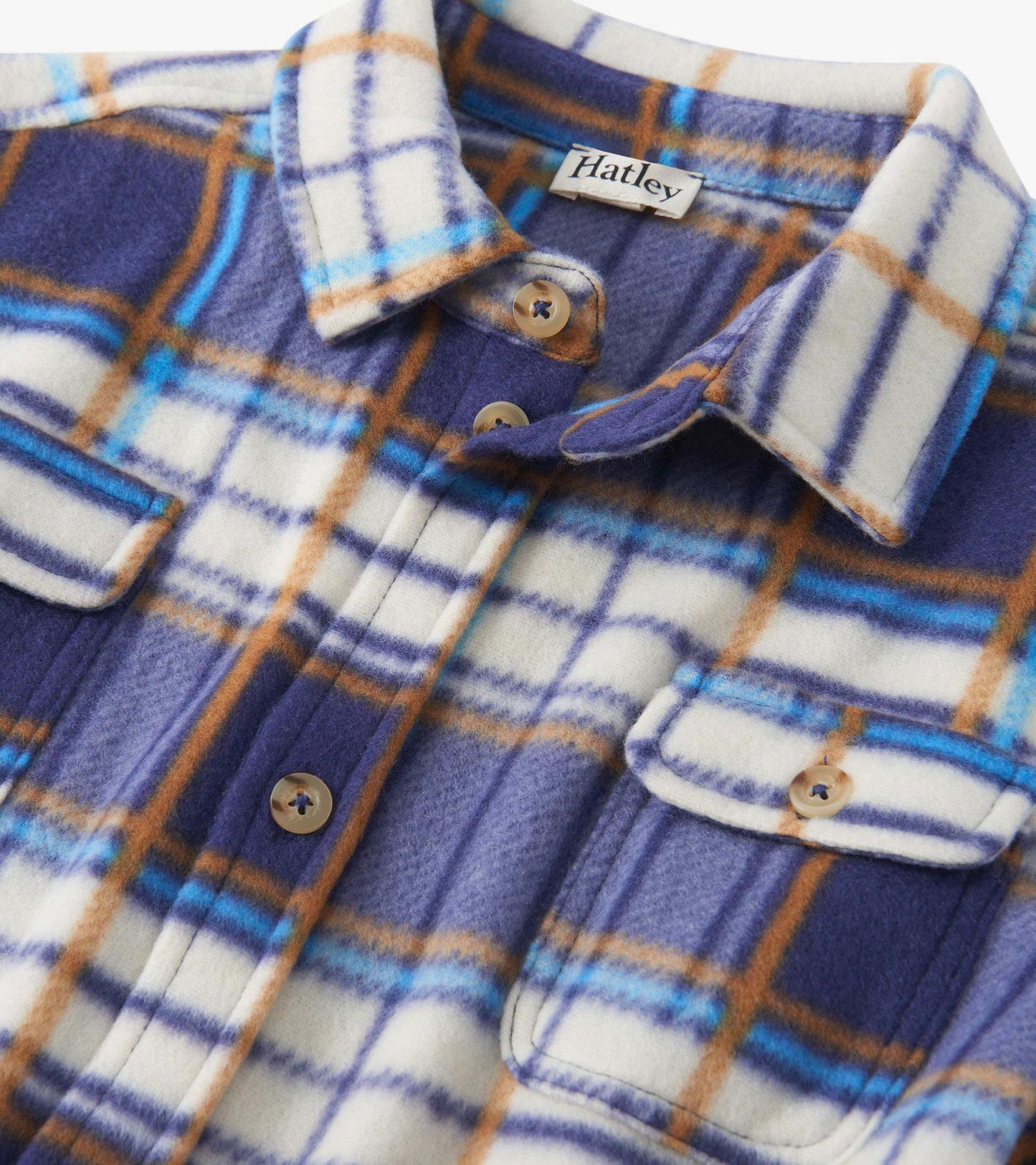 Plaid fleece button-up shirt in blue, brown, and white with two chest pockets and a collared neckline.