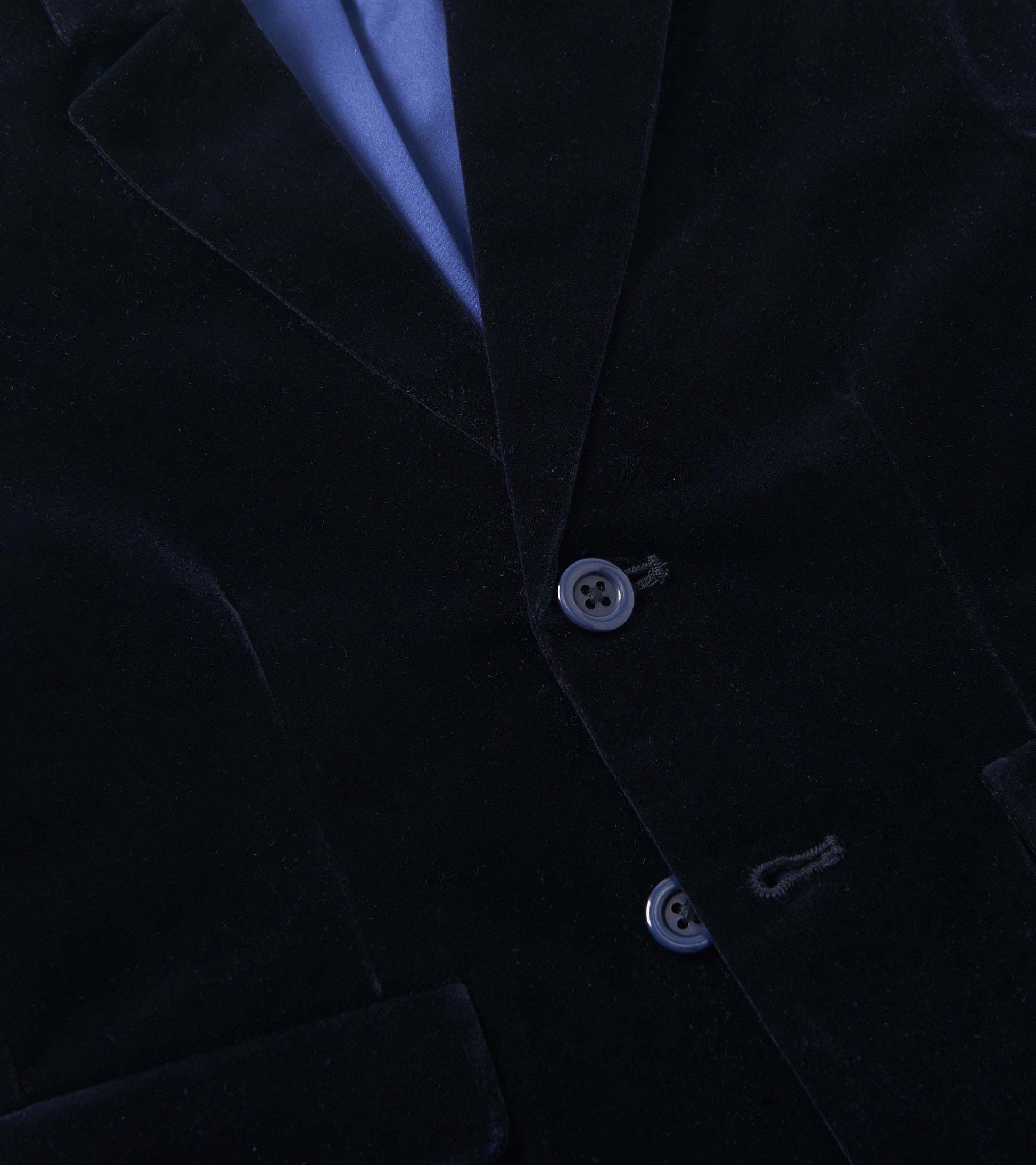 Navy velveteen holiday blazer with two buttons and a notched collar, featuring a blue satin lining.