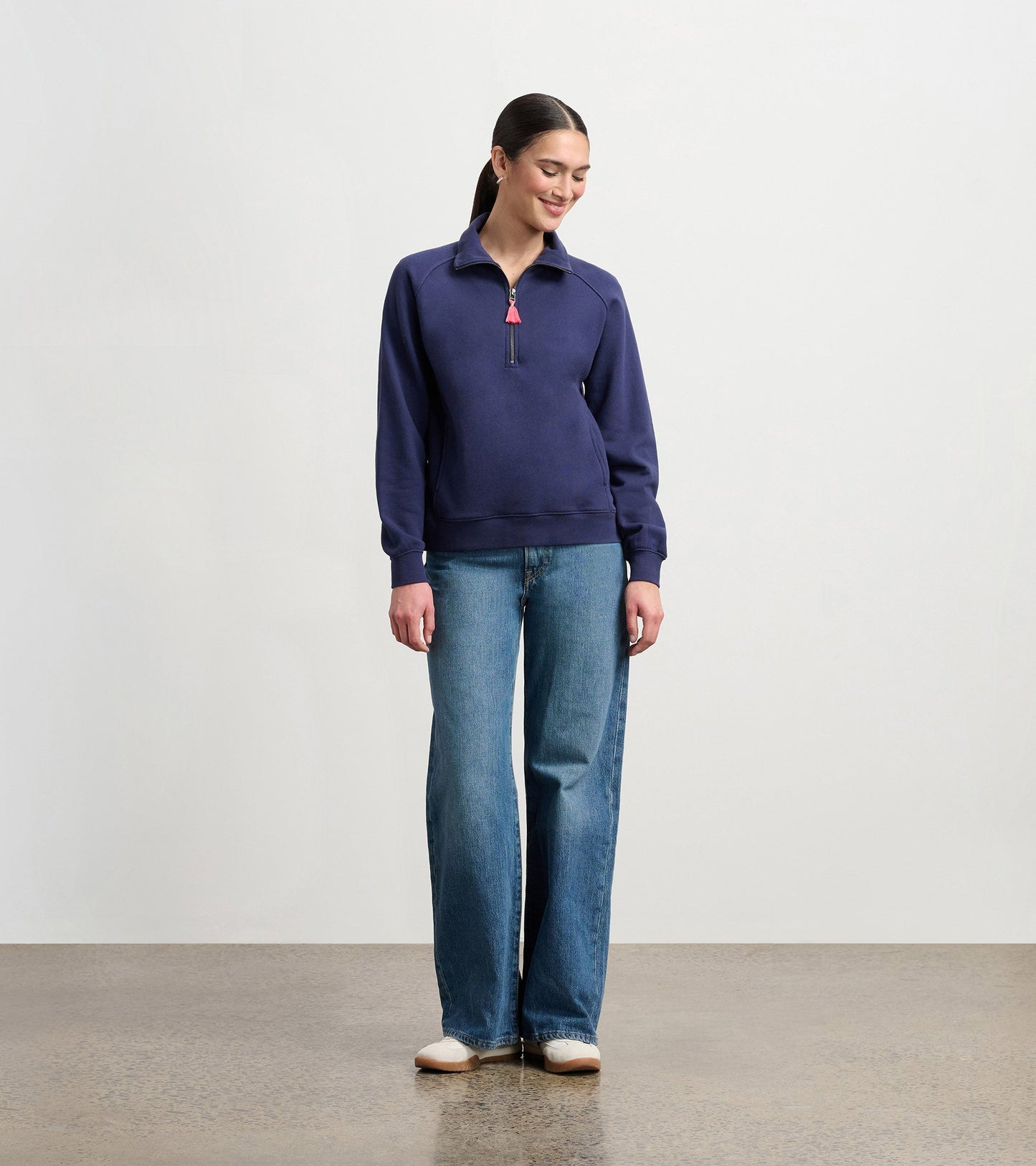 Mock neck pullover in patriot blue, featuring a zip closure and relaxed fit, paired with wide-leg jeans.