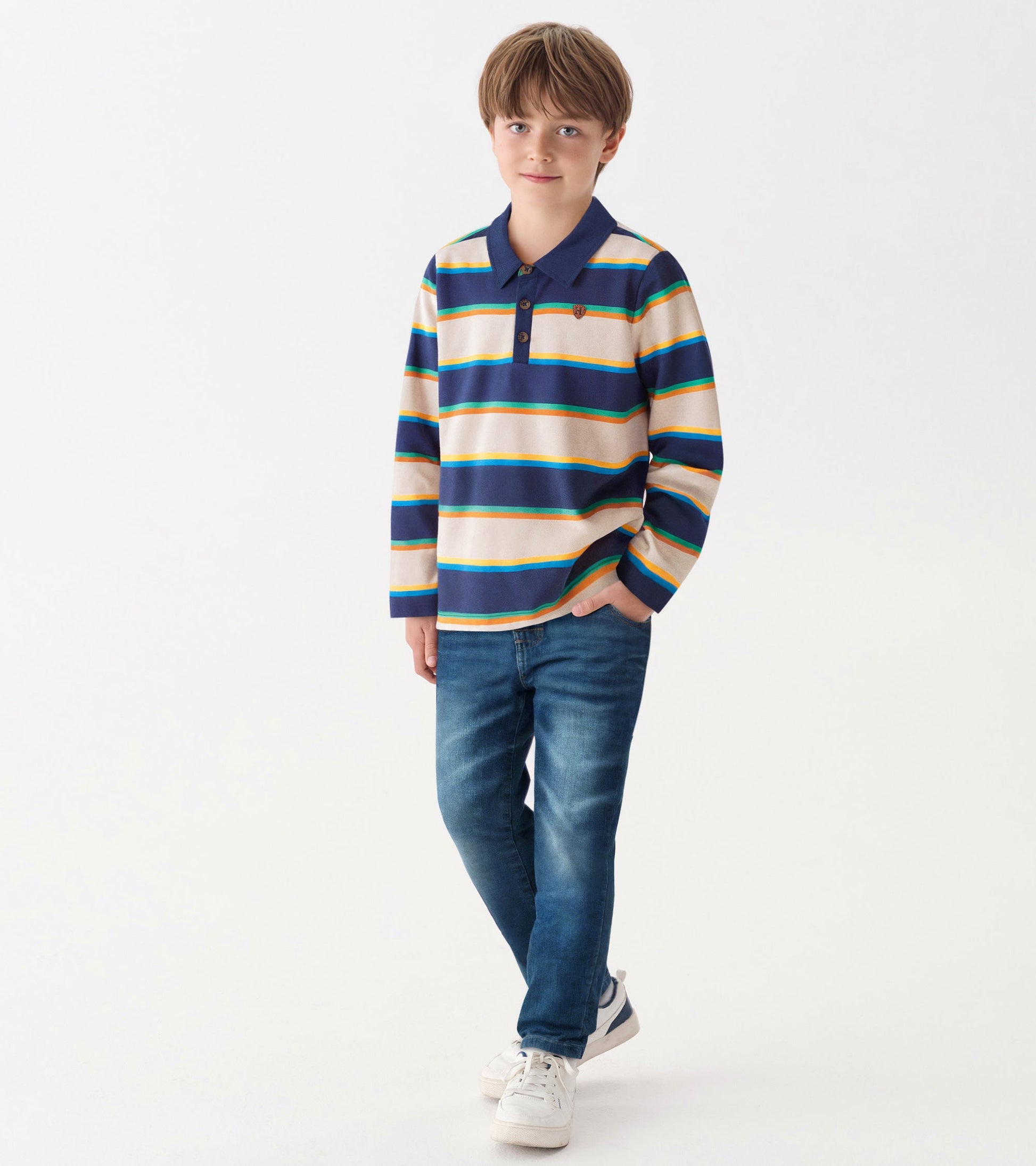 Navy and cream striped rugby shirt with a collar and button placket, worn by a boy with jeans and sneakers.