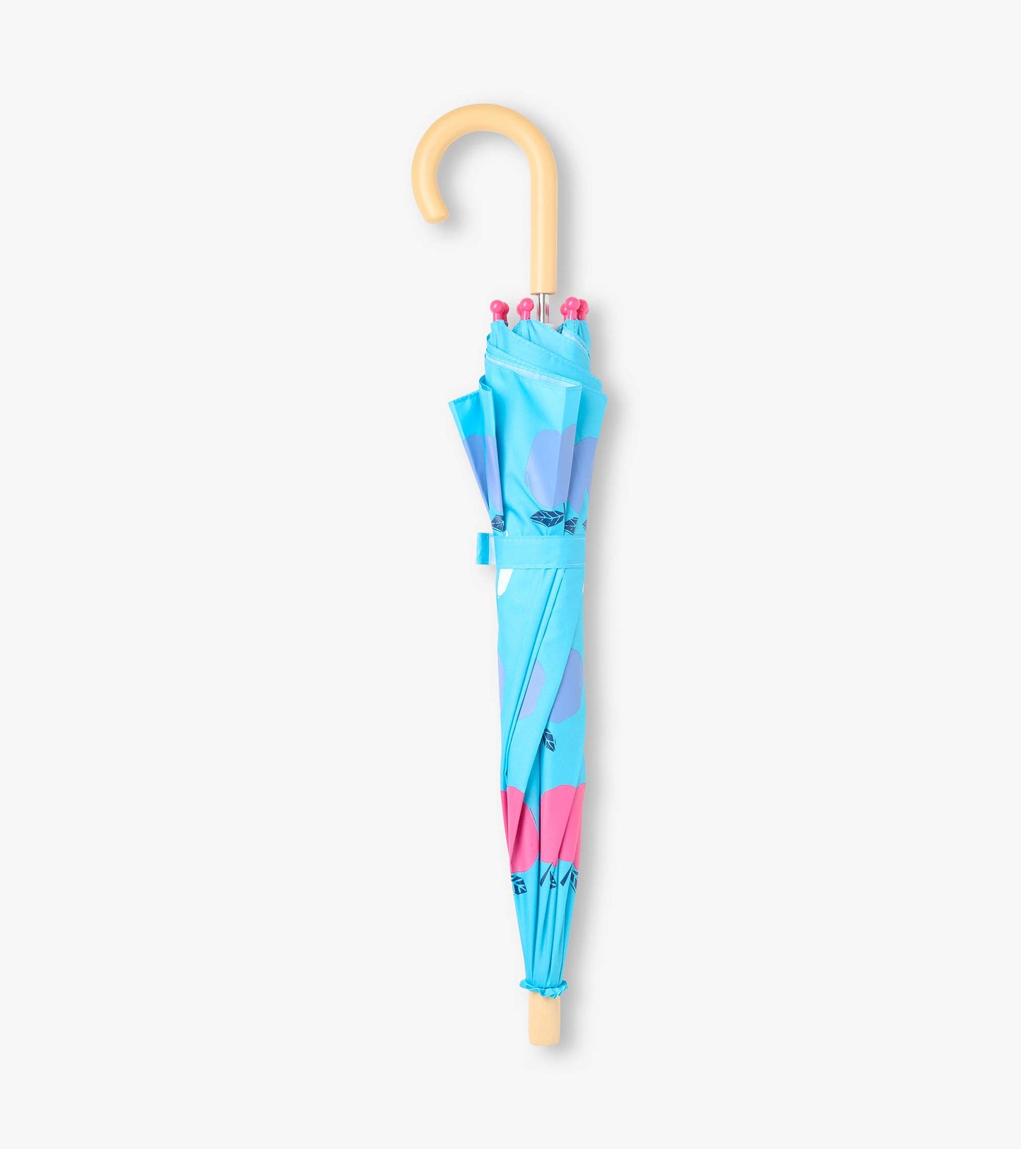 Closed blue kids umbrella with apple print, wrap strap, pink tips, and curved beige handle