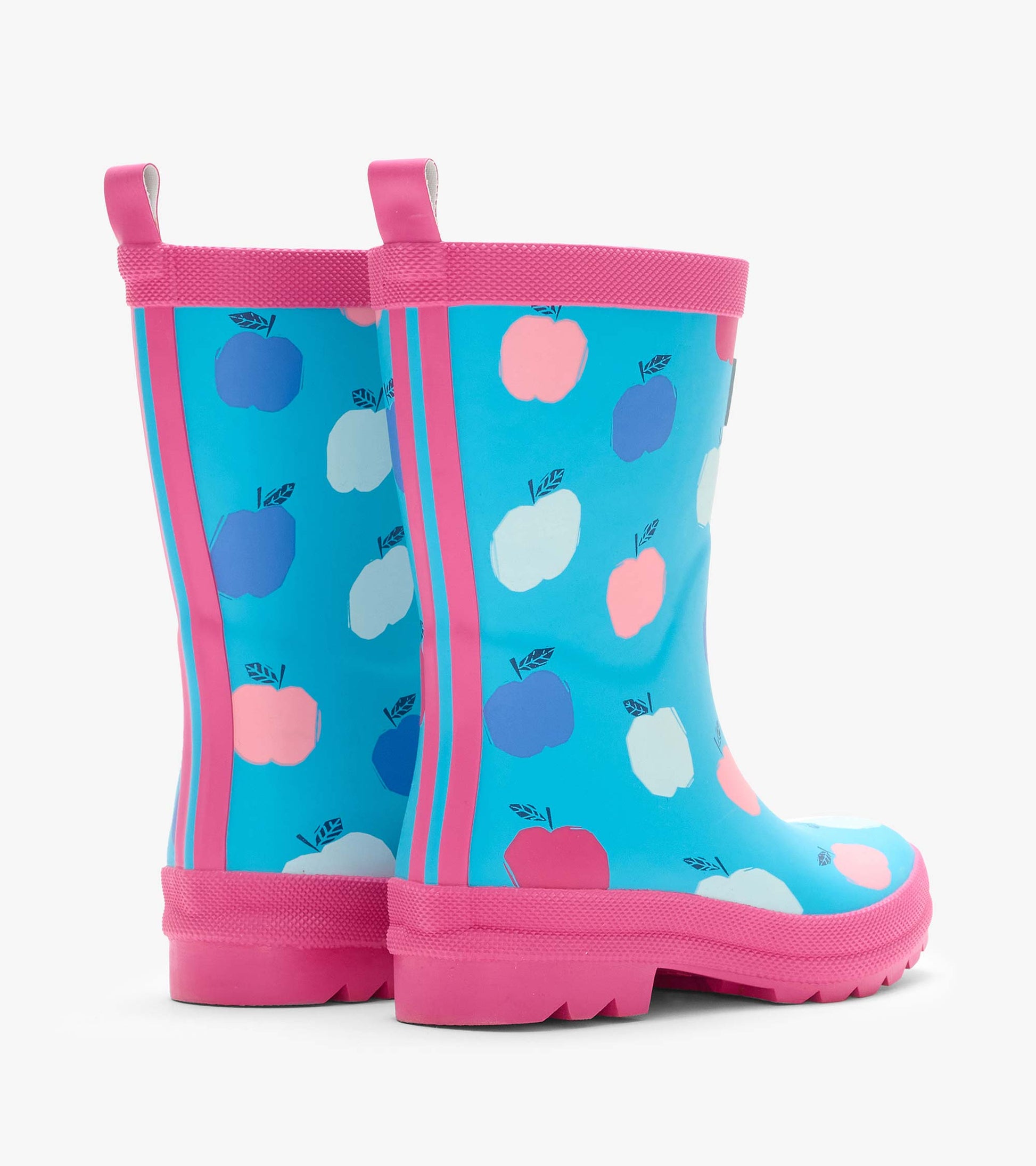 Pair of blue kids rain boots with pink trim and multicolor apple print, back angled view