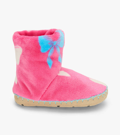 Side view of a pink slipper boot with blue bow print, white hearts, and tan sole