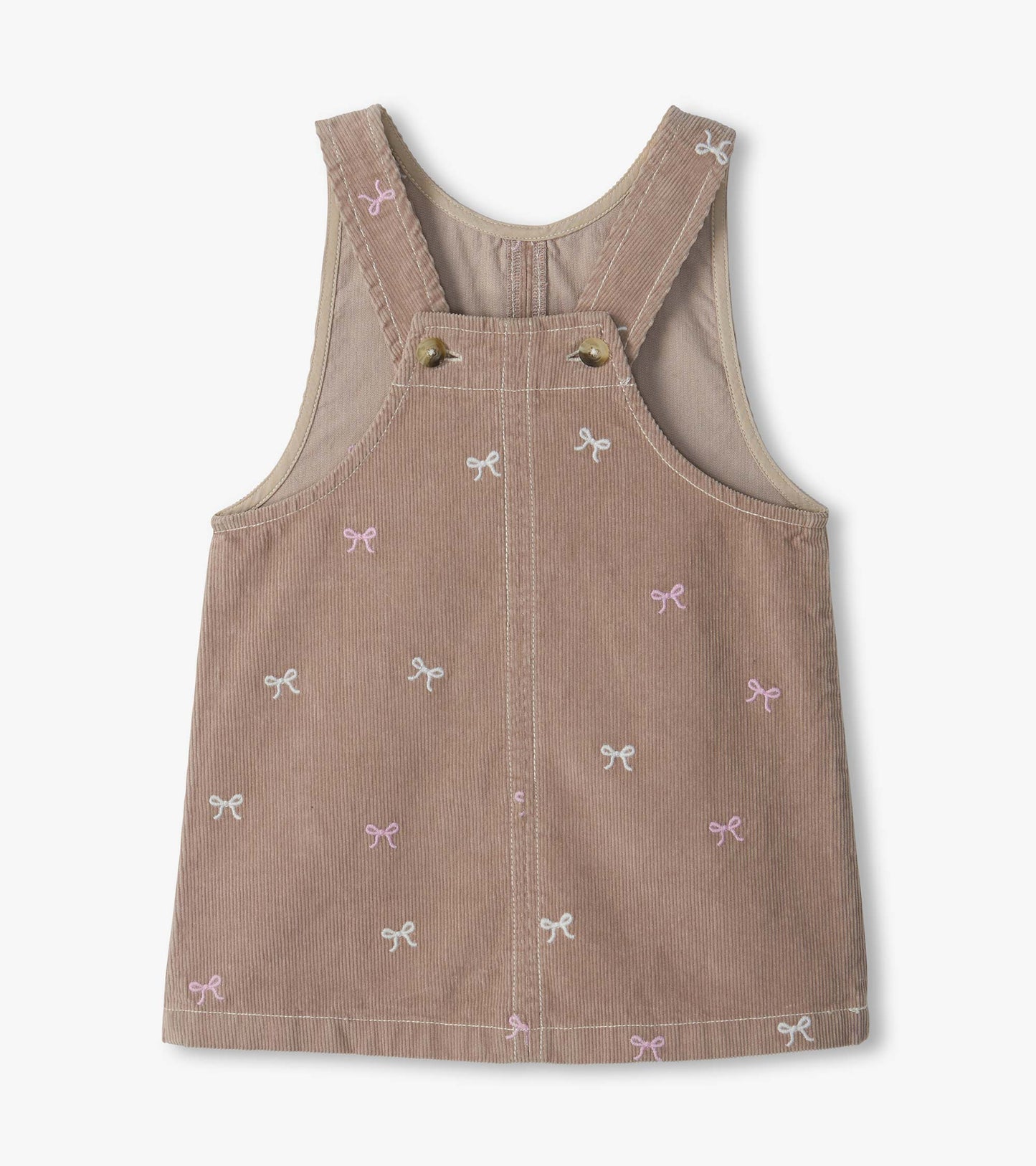 Back view of taupe pinafore dress with crossed straps, button fastening, and pink and white bow embroidery