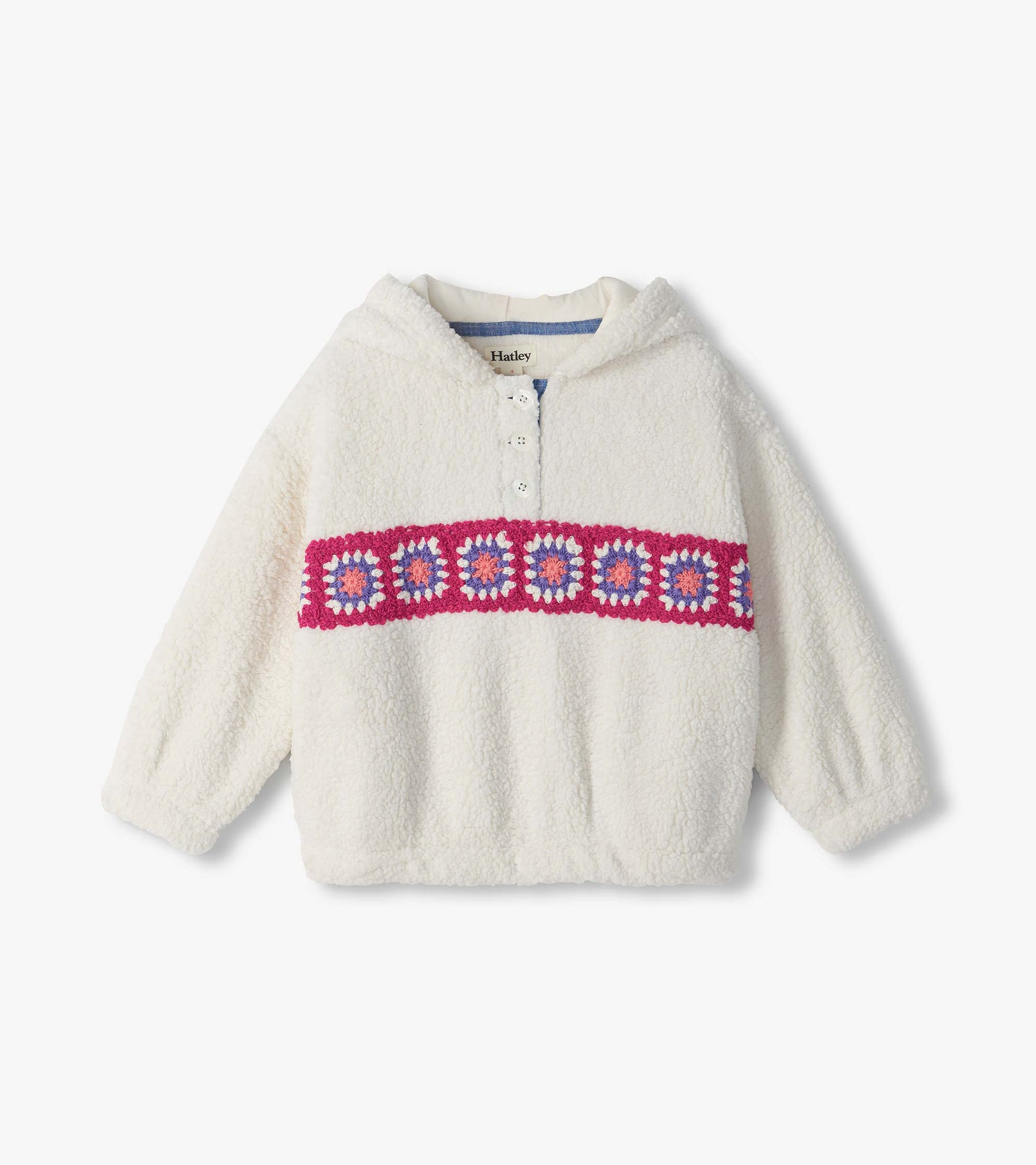Cream fuzzy pullover with collar, partial button placket, and pink, purple, and white crochet band across chest