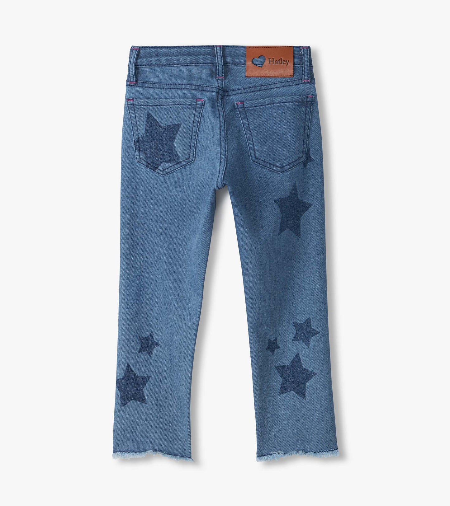Back view of blue slouchy jeans with dark star print, back pockets, Hatley patch, and frayed hems