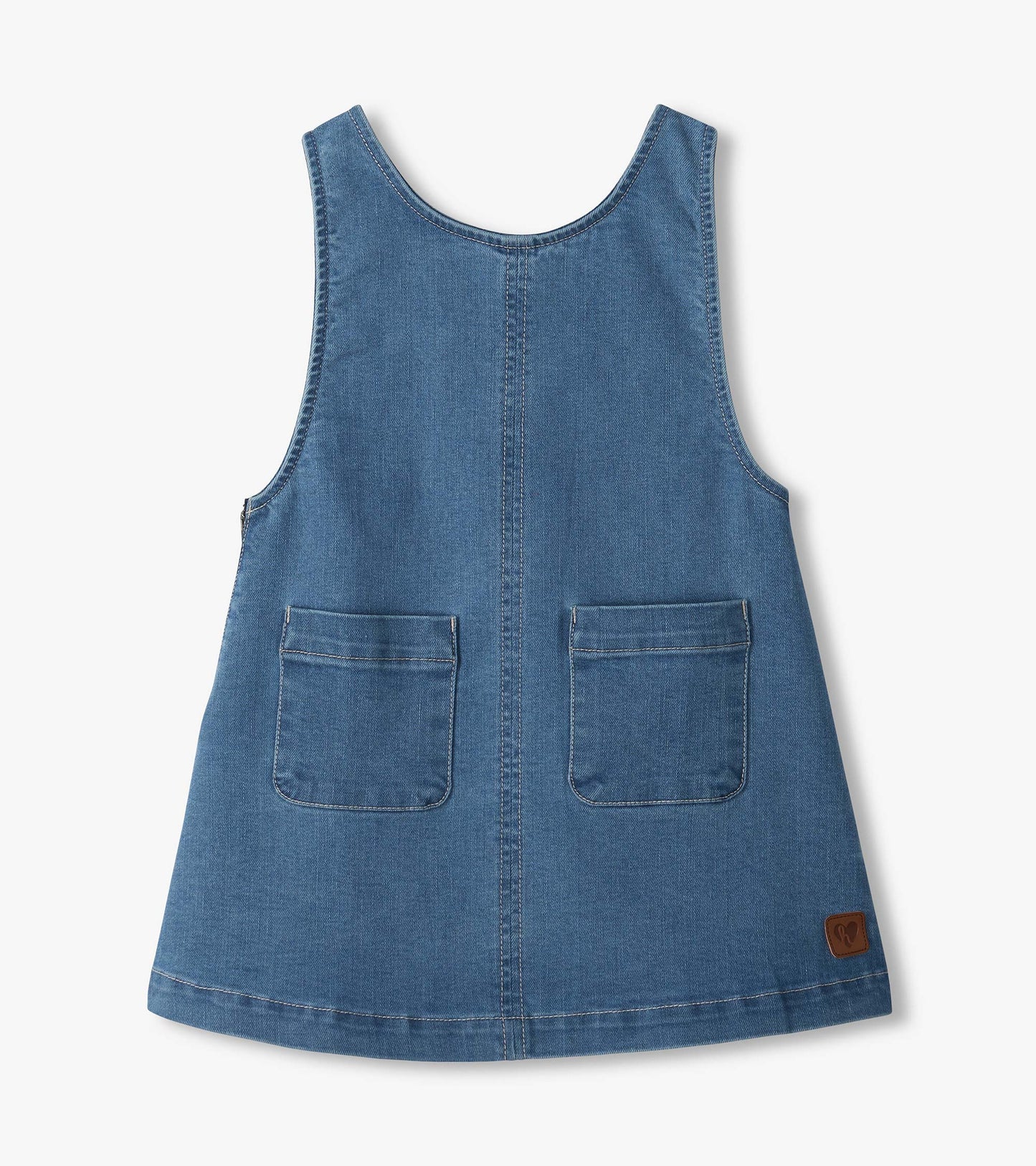 Front of blue pinafore dress with scoop neck, center seam, two front patch pockets, and small logo patch
