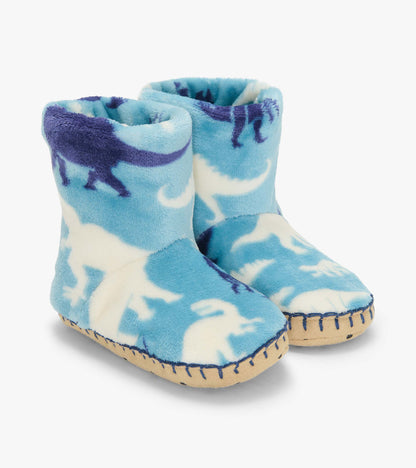 Pair of blue Dino Silhouette fleece slippers with white and navy dinosaur print and tan soles