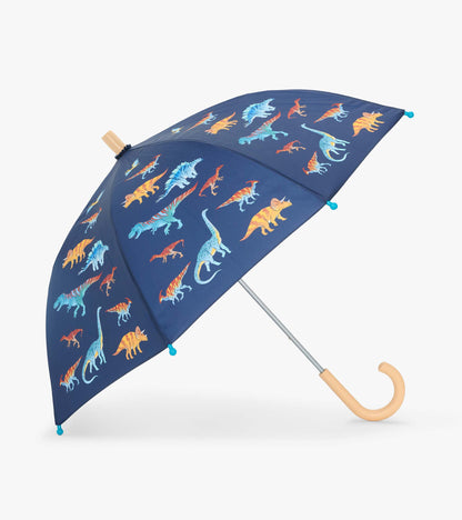 Open navy kids umbrella with colorful dinosaur print, blue tip covers, and curved light wood handle