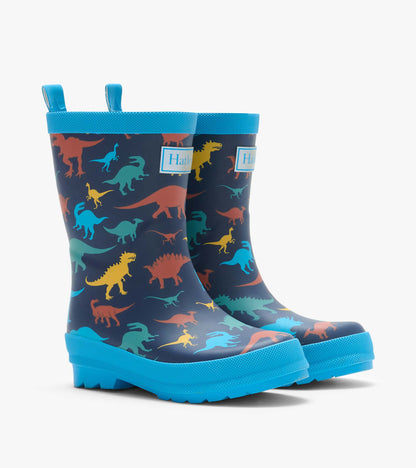 Pair of navy kids rain boots with colorful dinosaur print, bright blue trim and pull tabs
