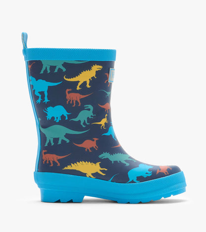 Side view of navy kids rain boot with colorful dinosaur print and bright blue sole and trim