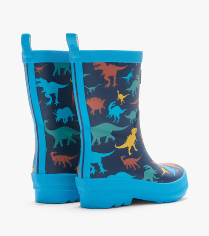 Back and side view of navy kids rain boots with colorful dinosaur print, blue trim and rear pull tabs