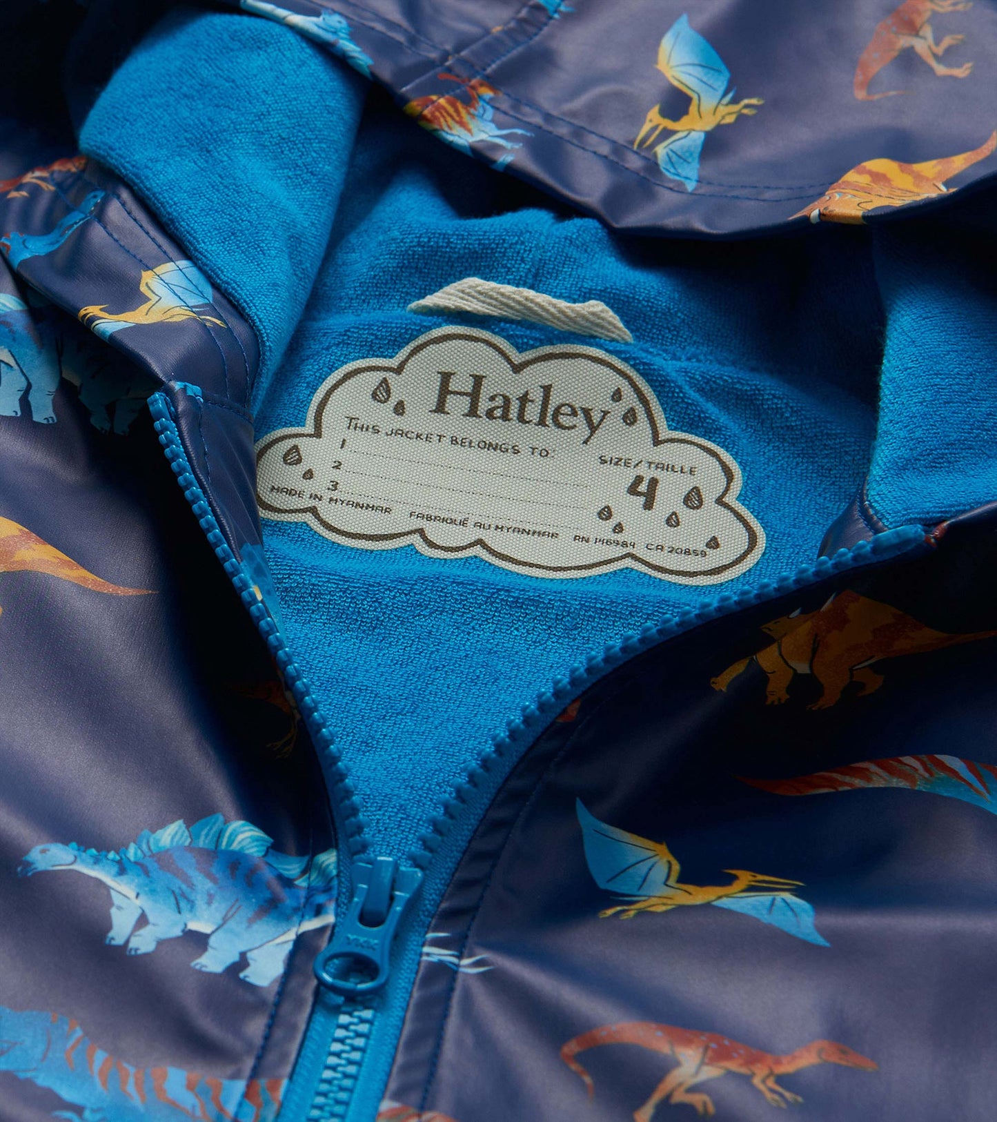 Close-up of blue lining and Hatley label inside the dinosaur print rain coat