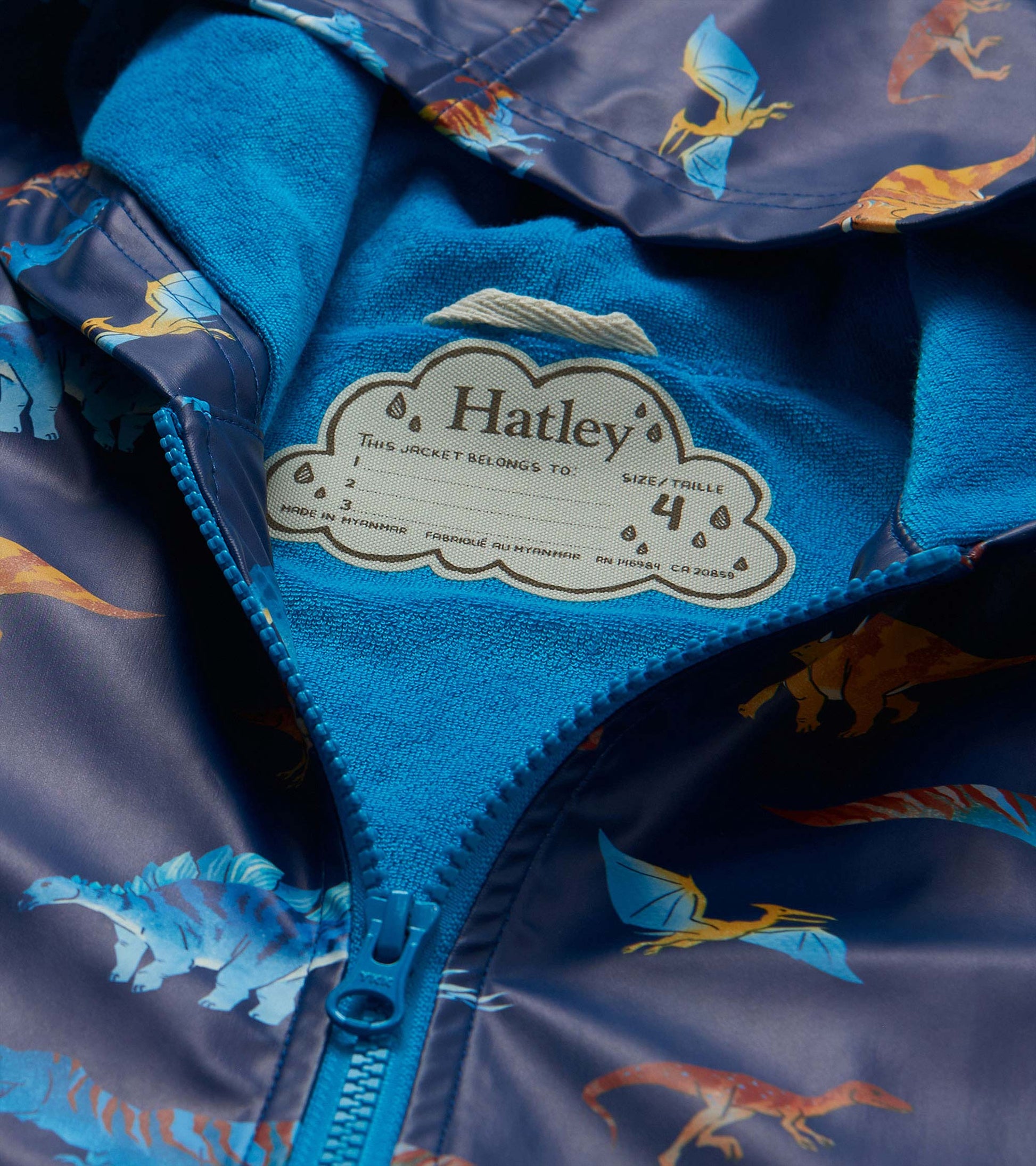 Close-up of blue lining and Hatley label inside the dinosaur print rain coat