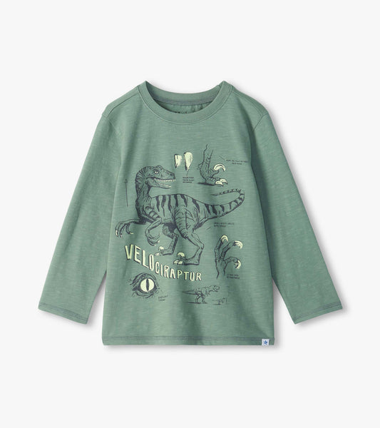 Green long sleeve crew neck tee with velociraptor graphic and sketch-style dinosaur details on the front