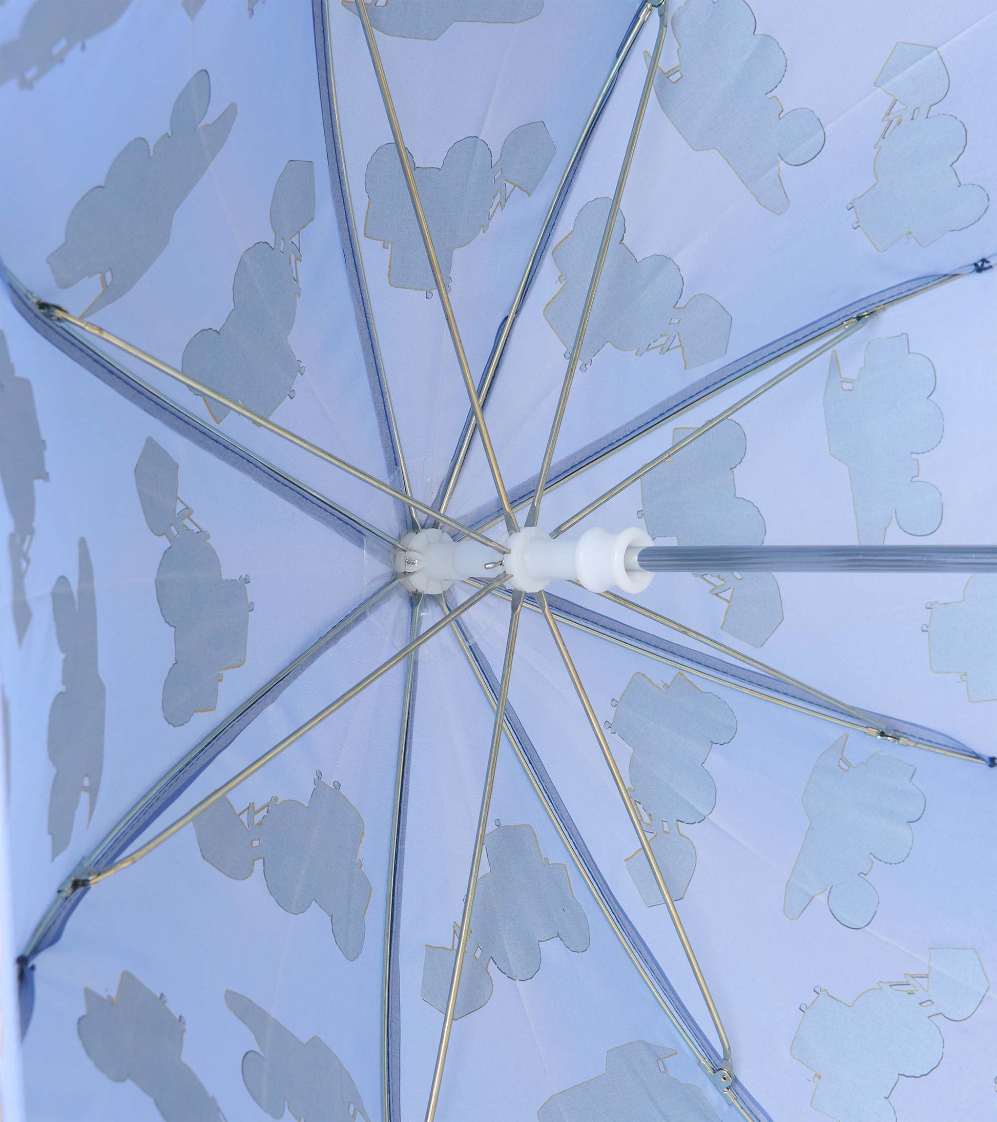 Underside of blue umbrella showing metal ribs and pale construction truck silhouettes