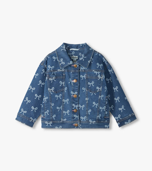 Front view of blue slouchy denim jacket with allover bow print, button front, and chest pockets