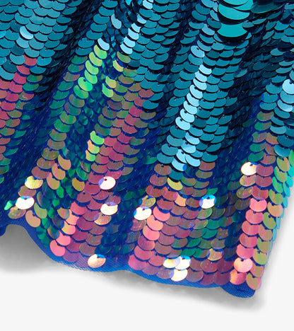 Close-up of iridescent sequins on the dress in blue, pink, purple and green tones