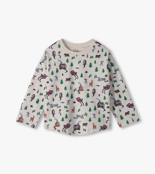 Kids long sleeve drop shoulder tee in heather beige with forest print of trees, cabins, bears, deer and trucks