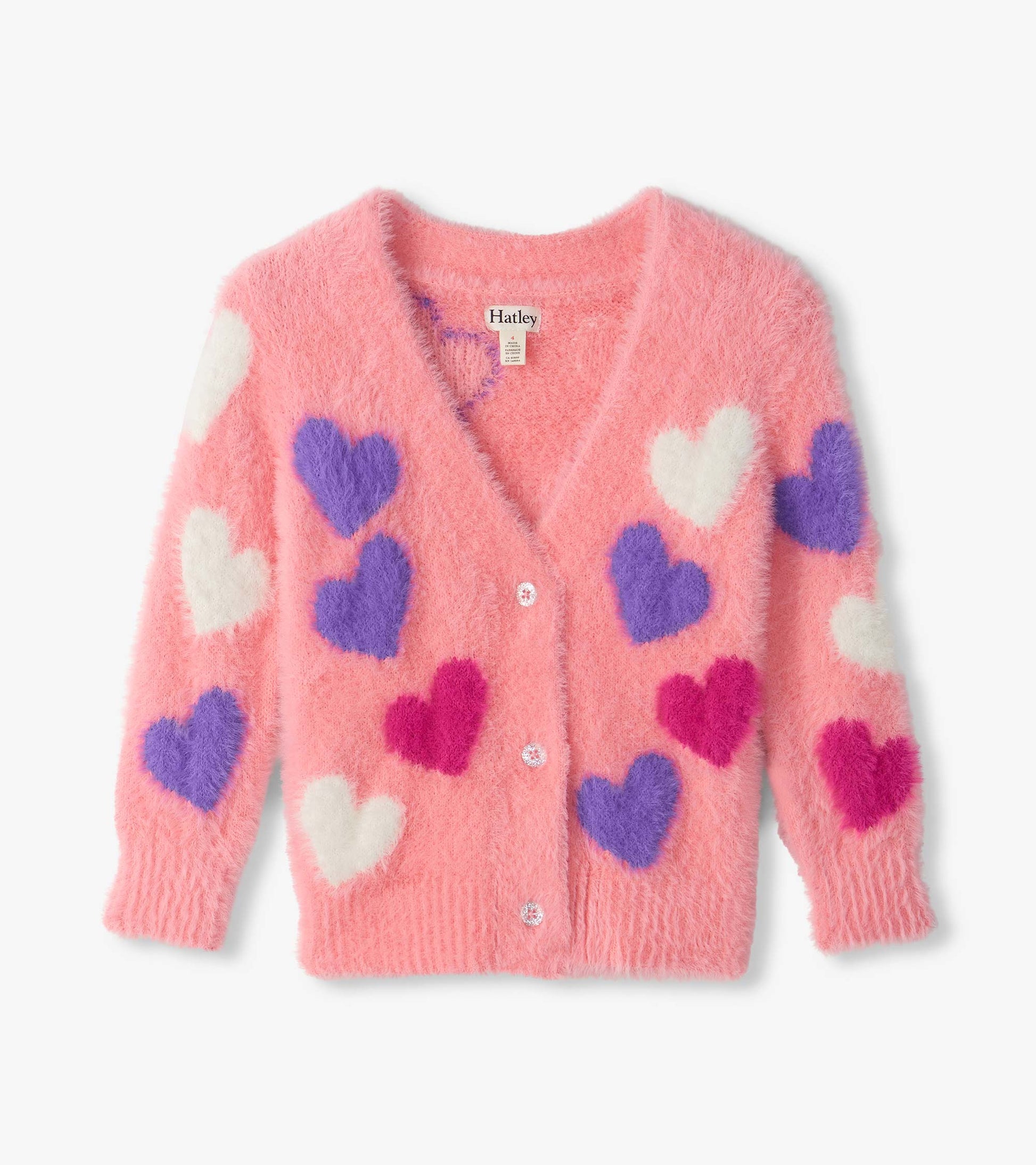 Front view of pink fuzzy cardigan with white, purple, and magenta heart pattern and button front