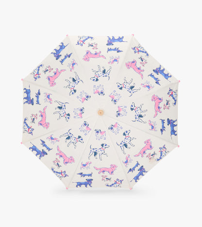 Top view of clear umbrella opened flat with pink, blue, and black dog illustrations