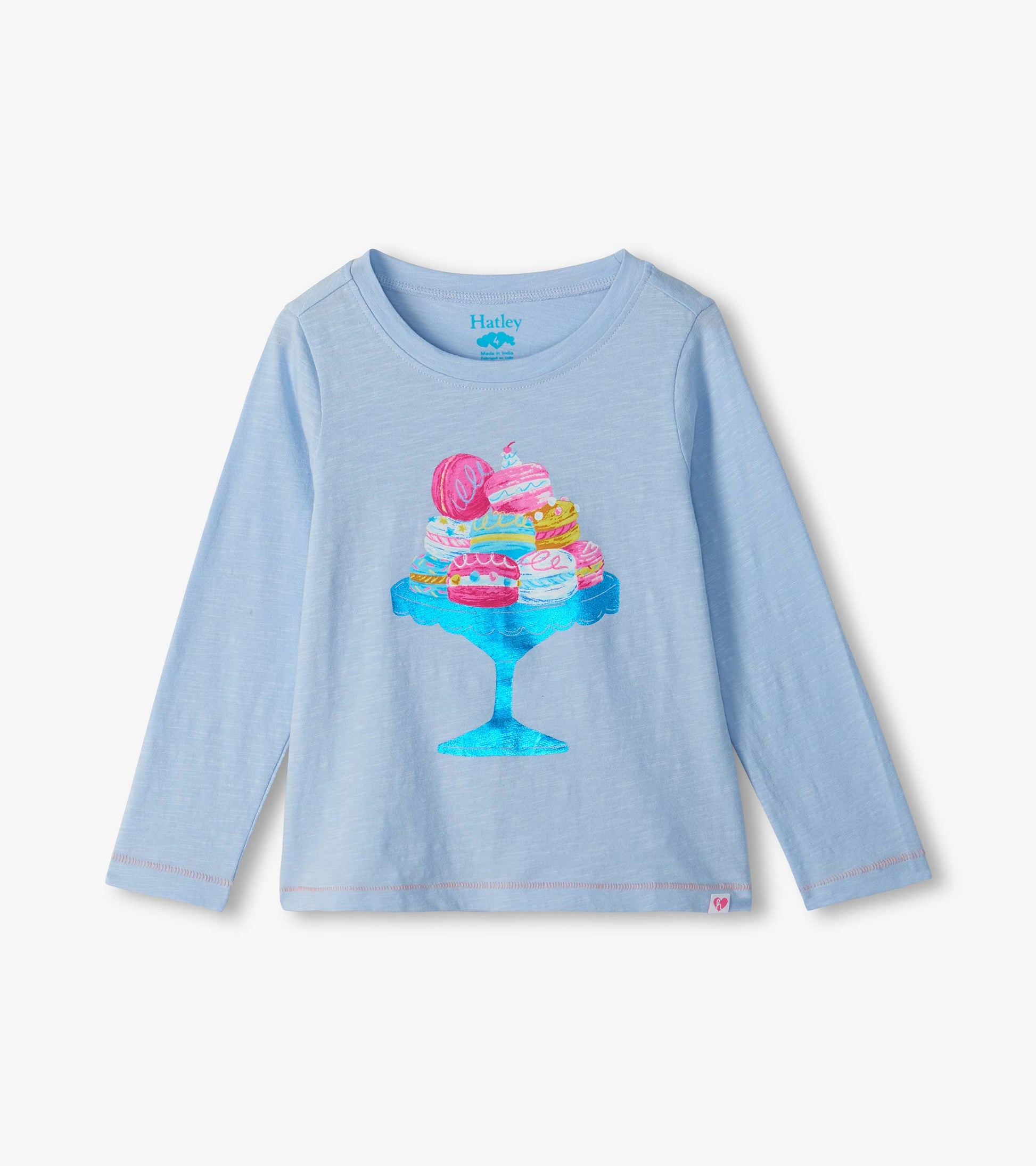 Light blue long sleeve tee with a colorful macaron stand graphic on the front