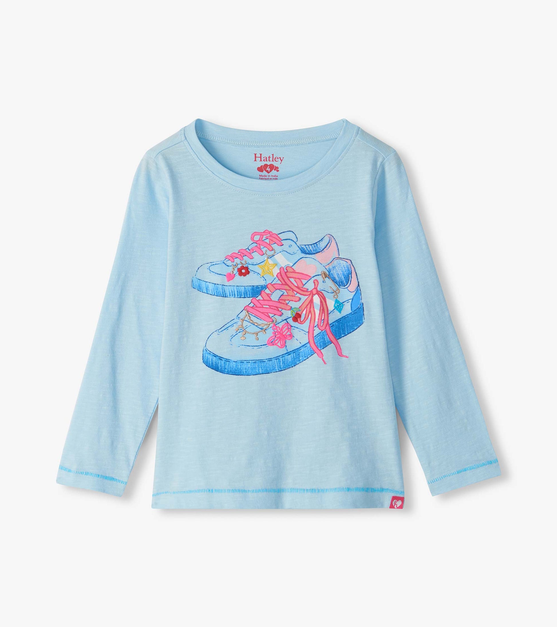 Light blue girls long sleeve tee with graphic of blue sneakers with pink laces and charm details