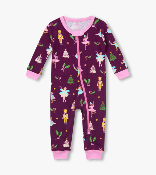 Front view of infant coverall in dark purple with pink trim and zipper, nutcracker, ballerina and tree print