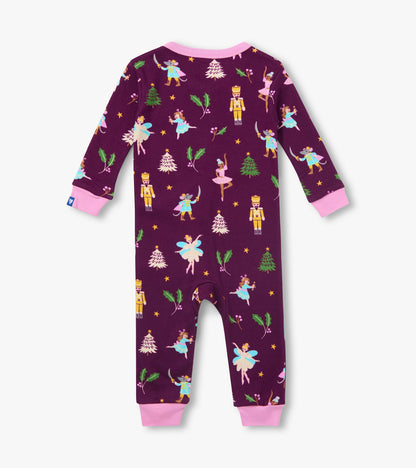 Back view of infant coverall in dark purple with pink cuffs and holiday ballet print with nutcrackers and trees