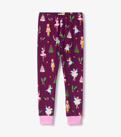 Purple pajama pants with pink cuffs and Nutcracker print featuring ballerinas, soldiers, holly and trees