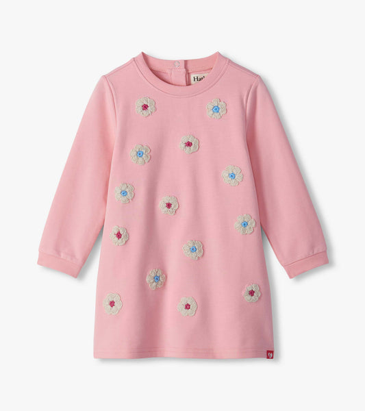 Infant orchid pink long-sleeve dress with cream flower appliqués and blue and pink centers