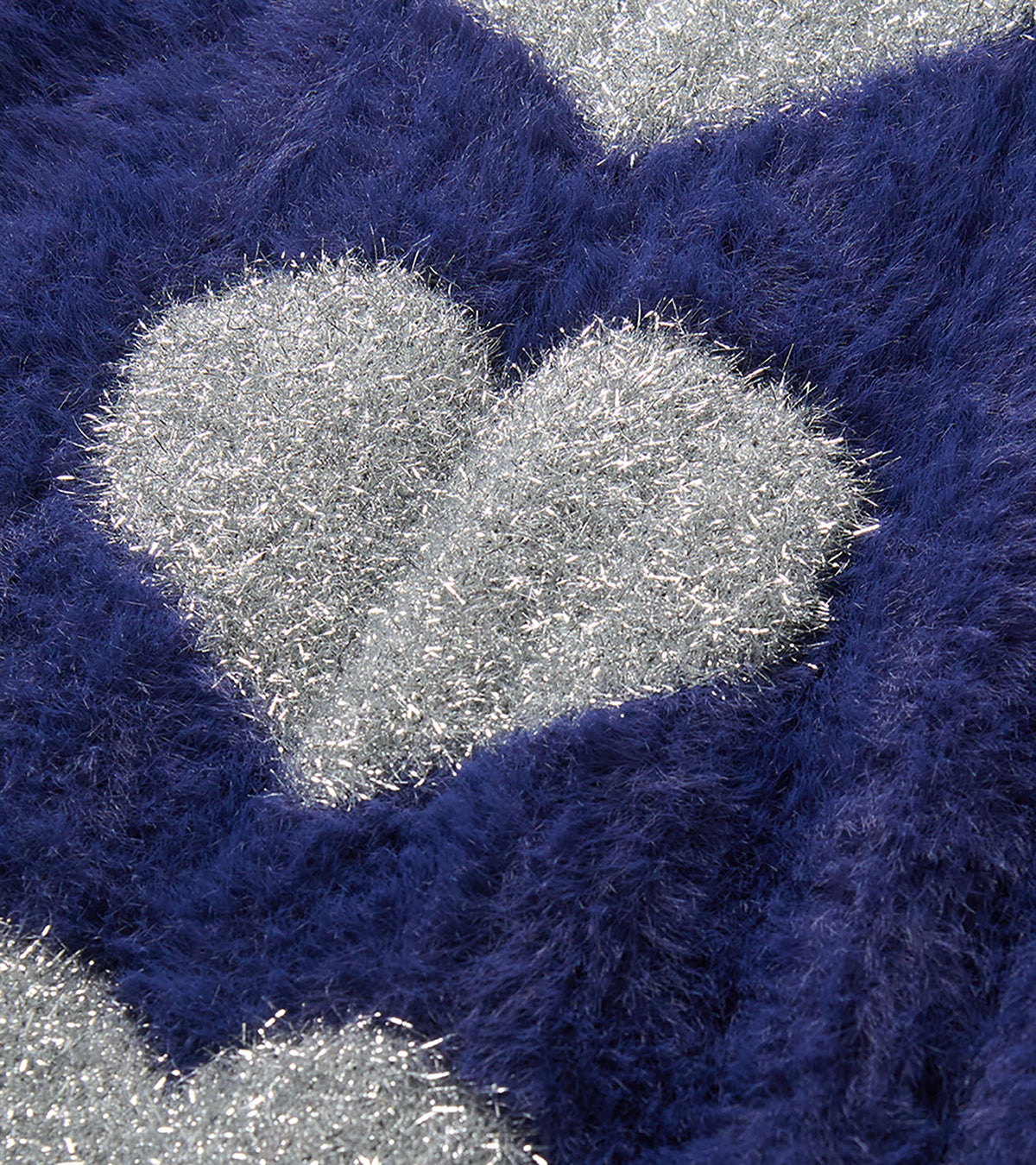 Close-up of silver heart detail on the patriot blue fuzzy sweater dress
