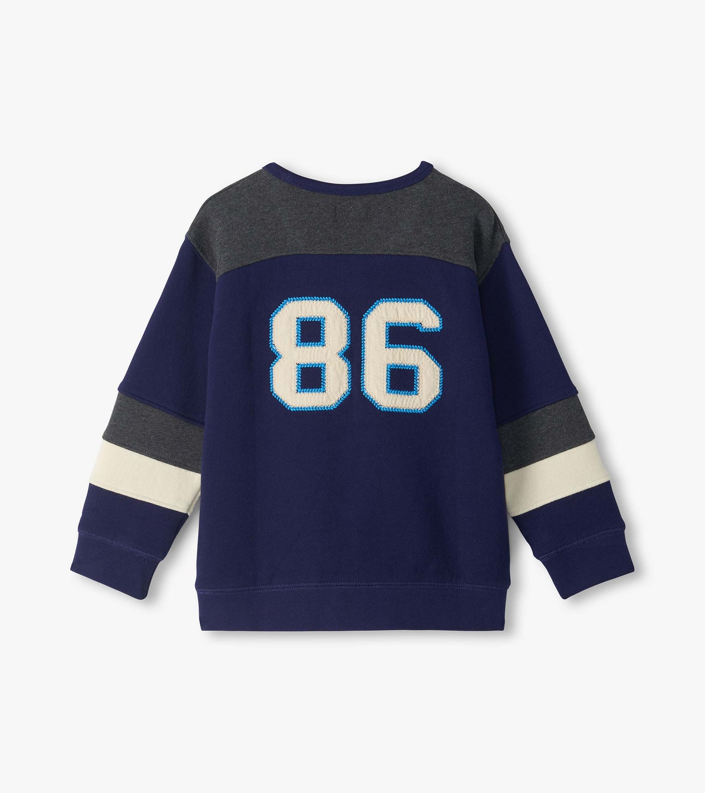 Back view of kids blue pullover top with dark gray yoke, cream sleeve stripes, and large 86 graphic