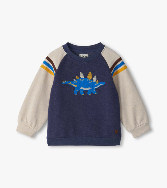 Kids pullover sweatshirt with blue body, cream sleeves, striped shoulders, and blue stegosaurus graphic