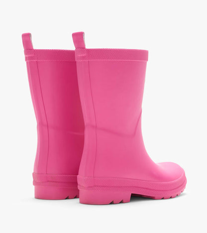 Rear angled view of two bright pink kids rain boots with pull tabs and textured lug soles